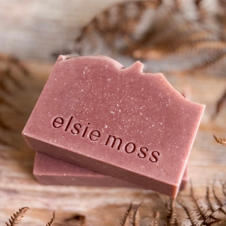 Two pink soap bars with &