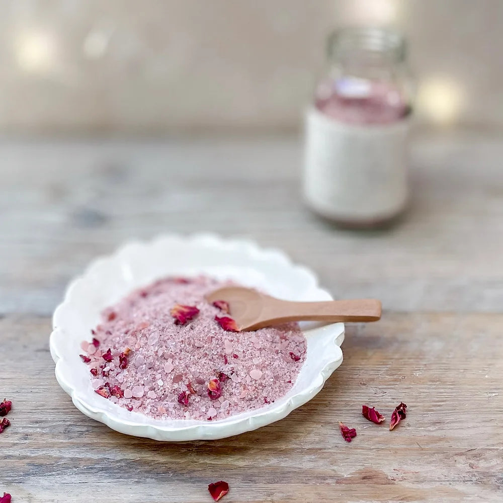 Rest bath soak displayed on a white dish with wooden spoon