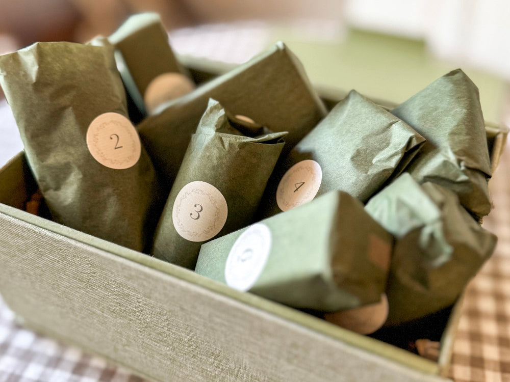 Green wrapped items with numbers in a box on a checkered fabric background