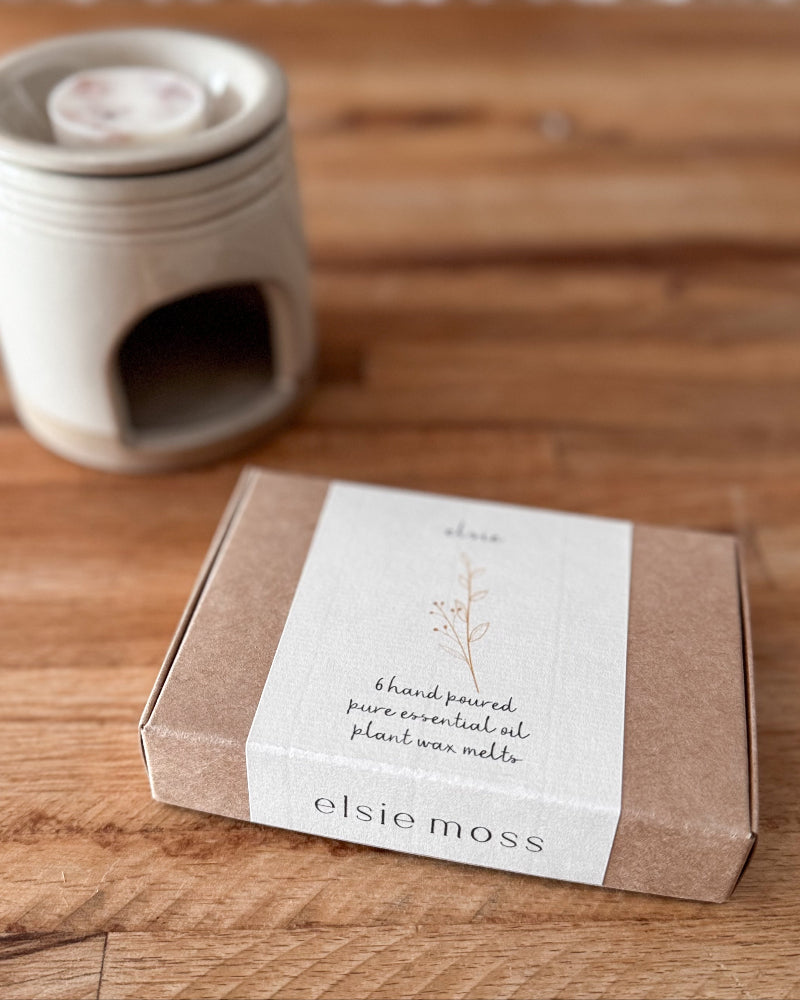 A boxed candle product labeled &