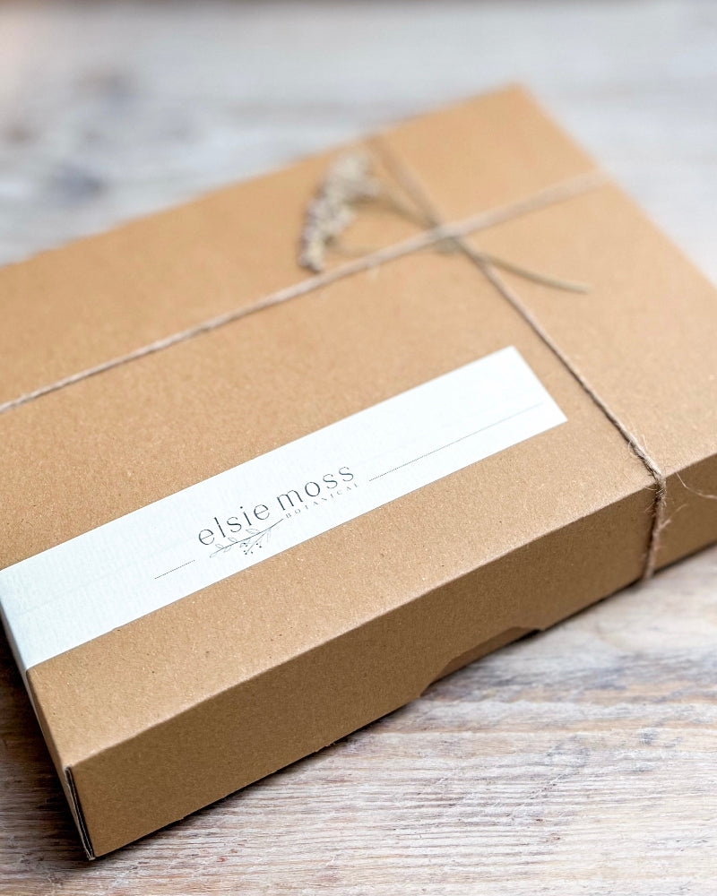 Brown cardboard box with a white label on a wooden surface