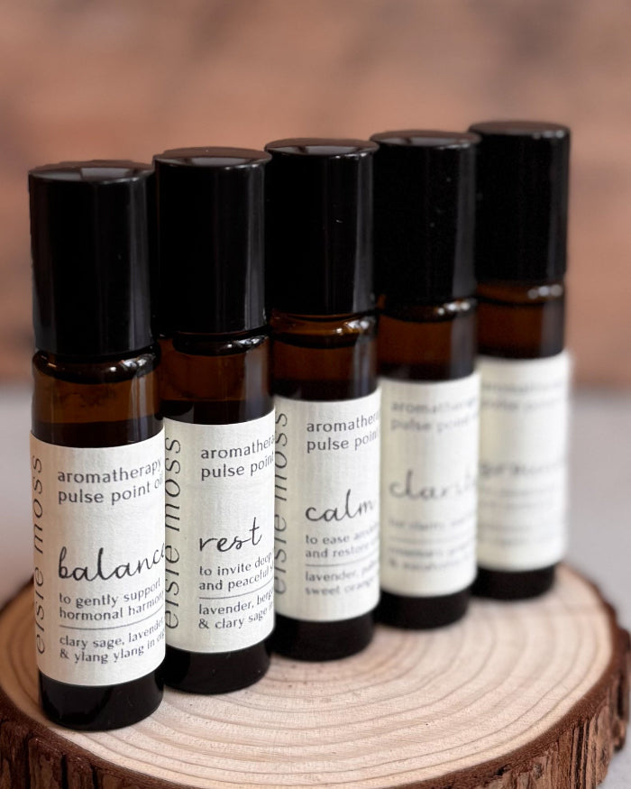 Set of aromatherapy roller bottles on a wooden surface with a blurred background