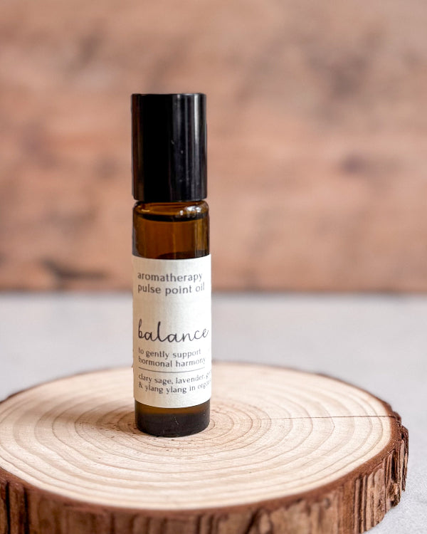 Roll-on bottle of aromatherapy pulse point oil labeled &
