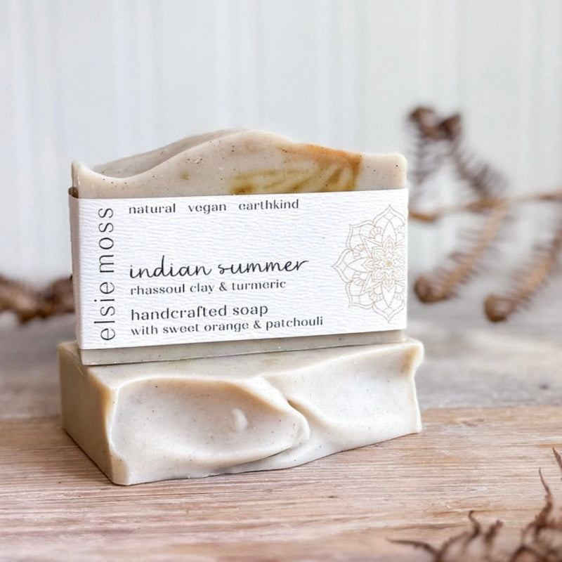 Handcrafted soap bar with a visible label on a wooden surface
