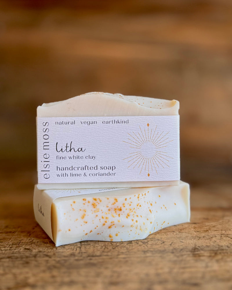 Handcrafted soap bar with a visible label on a wooden surface