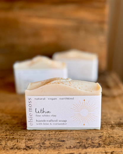 Handcrafted soap bar with packaging on a wooden surface