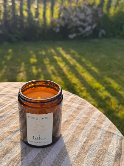 Candle in an amber jar labeled &