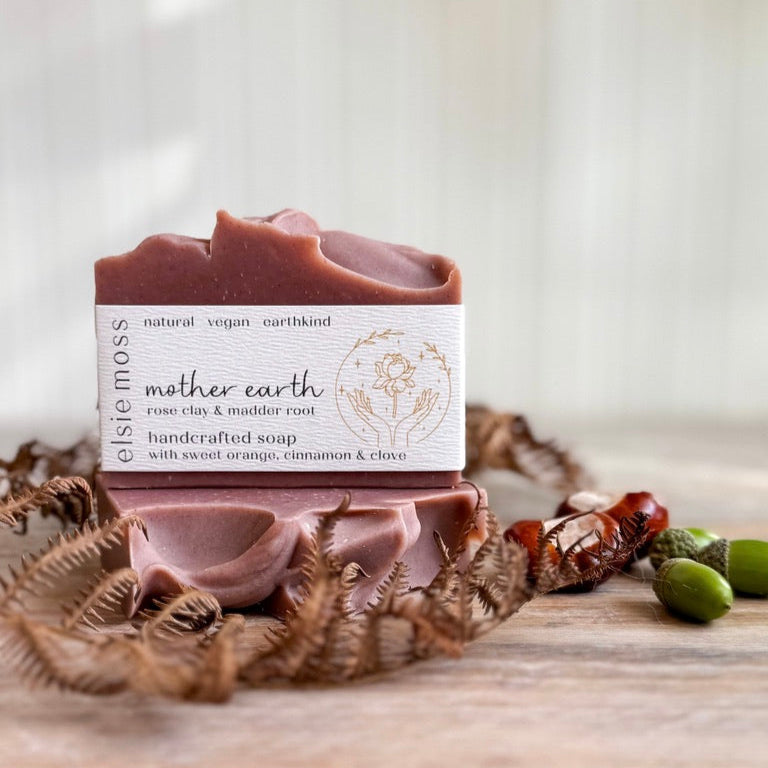 Bar of soap with a label on a wooden surface with natural elements