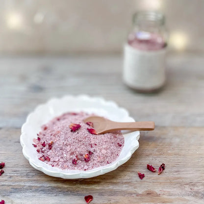 Rest bath soak displayed on a white dish with wooden spoon