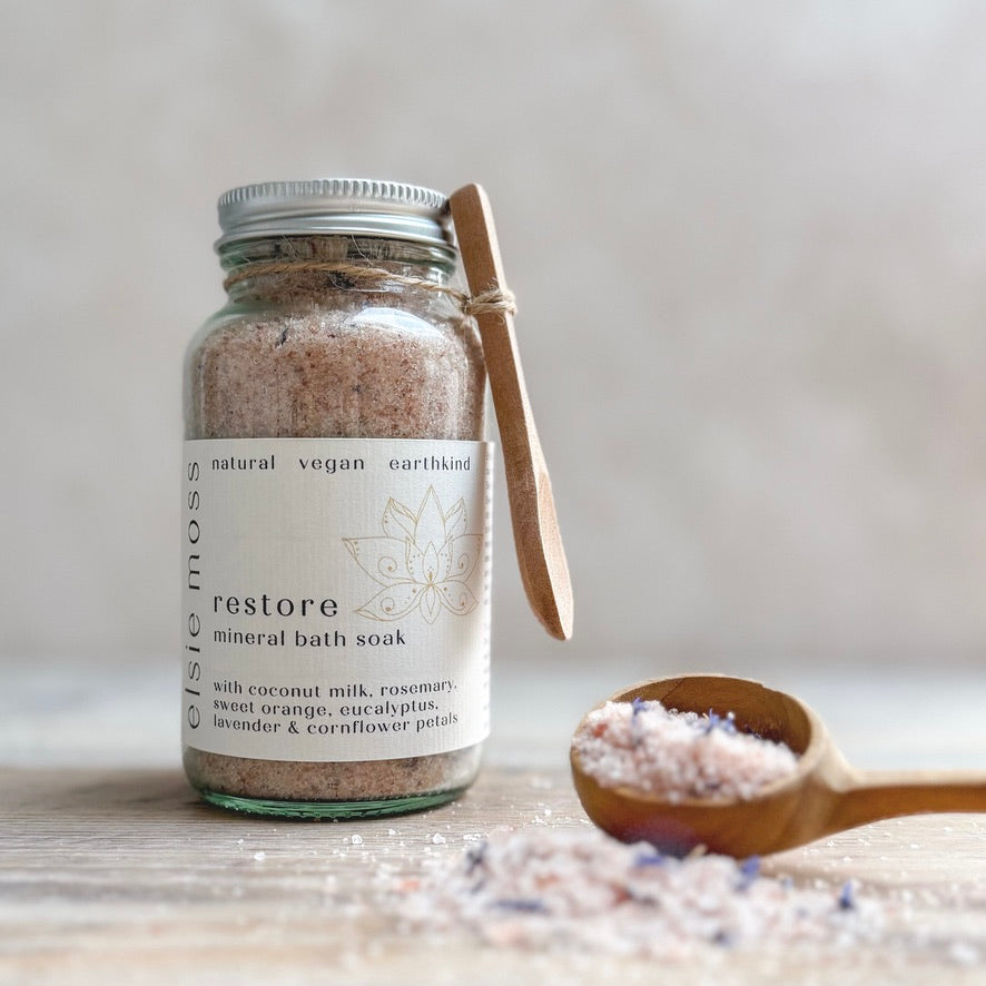 Jar of Restore Bath Soak with wooden spoon