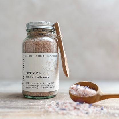 Jar of Restore Bath Soak with wooden spoon