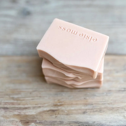 three bars of pale pink soap bars stacked without packaging
