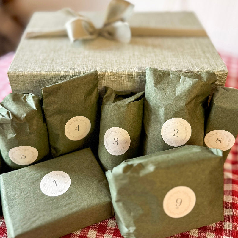 Green gift boxes with numbers on a checkered tablecloth