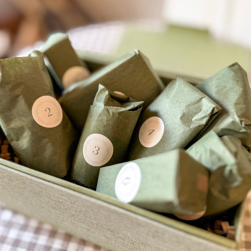 Green wrapped packages with numbers in a box
