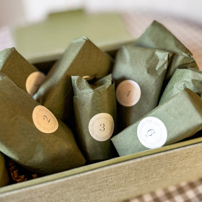 Green wrapped items with numbered labels in a box