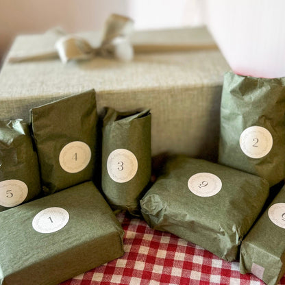 Green packages with numbered labels on a red and white checkered tablecloth