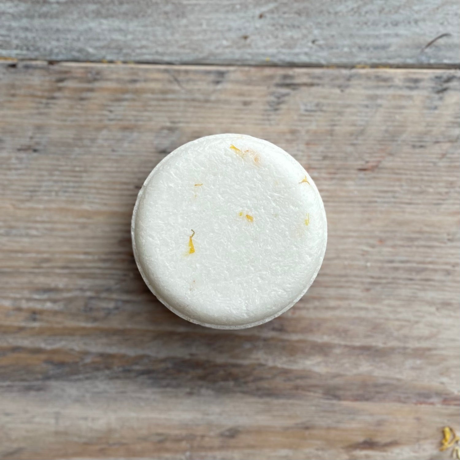 White shampoo bar on a wooden surface