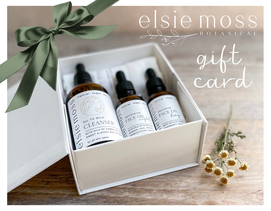 Elsie Moss Botanical skincare product set with a gift card on a wooden surface.