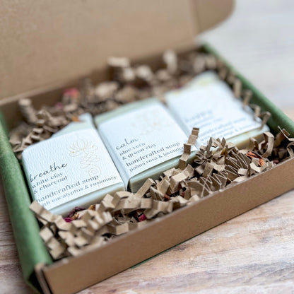 Three bars of soap in a box with decorative paper