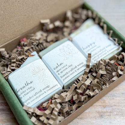 Three handcrafted soap bars in a box with decorative paper