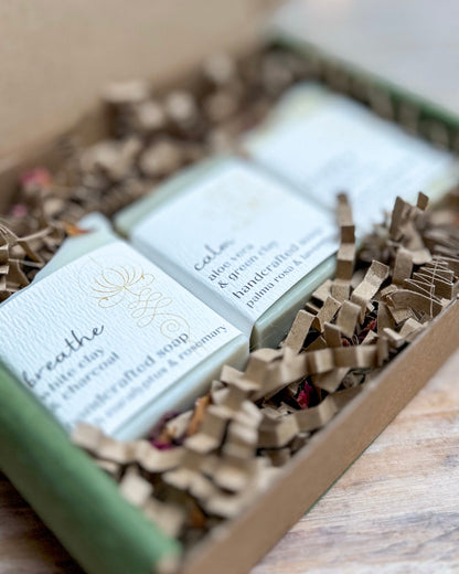 Three bars of soap in a box with decorative paper