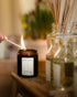 Person lighting a candle labeled &