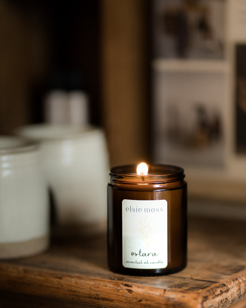 Candle in a glass jar labeled &