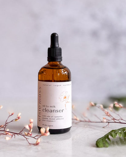 Bottle of oil to milk cleanser with a label on a light background