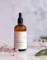Bottle of oil to milk cleanser with a label on a light background