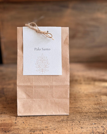Kraft paper bag with a white label featuring &